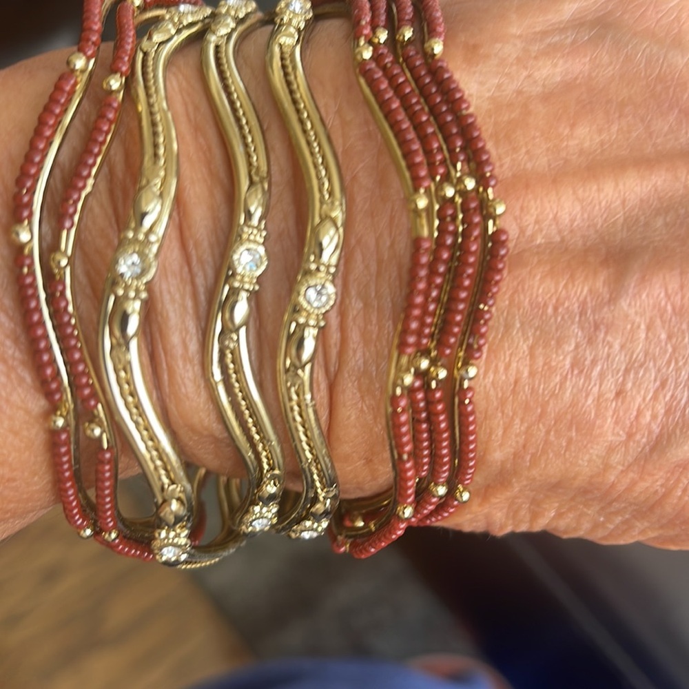 Bangle bracelet, gold toned, nine pc bejeweled and beaded,burnt brown